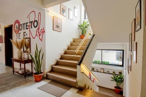 a staircase in a house with potted plants at FabHotel Sai Raj - Nr Zeel College in Pune