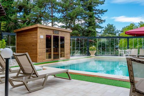 a small swimming pool with a building next to it at Hotel & Spa Tino Sveti Stefan in Ohrid