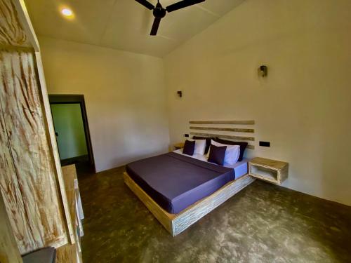 a bedroom with a bed with blue sheets and pillows at Sesatha lake Kandy in Kandy
