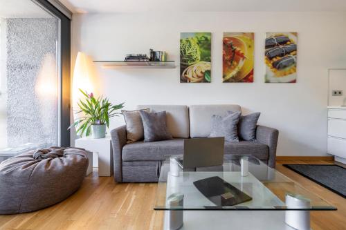 a living room with a couch and a glass table at Ferienwohnung iq-Sports in Bludenz