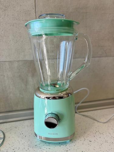 a blender with a green top sitting on a counter at StaySanto in Loures in Loures