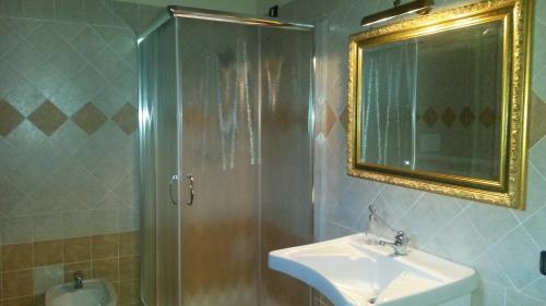 a bathroom with a shower and a sink and a mirror at Borgo Santa Lucia in Cropani