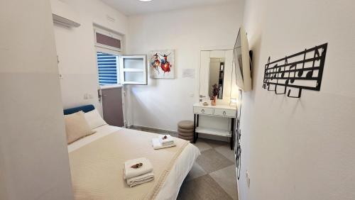 a small bedroom with a bed and a desk at FREE parking Marli 4 - Room with private entrance - in Dubrovnik