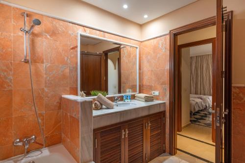 a bathroom with a sink and a shower and a mirror at Villa Los Alisios 58 in Playa Blanca