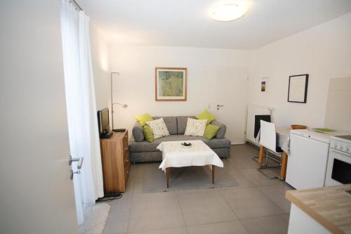 a living room with a couch and a table at Ferienwohnung Im Schiller in Wiesenbronn