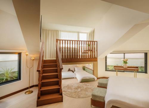 a bedroom with a spiral staircase and a bed at Palazzo President in Split
