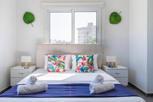 a bedroom with a large bed with two stuffed animals on it at Phoenix 2-Bedroom Apartment in Larnaca