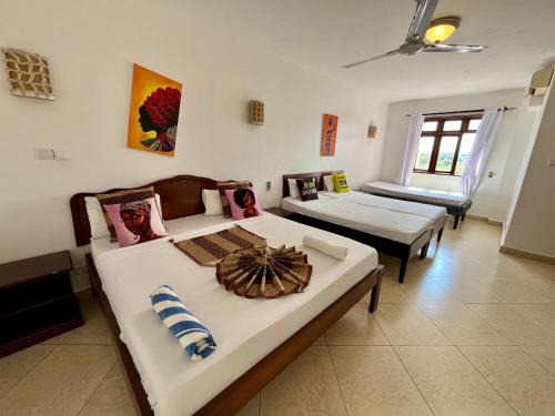 a bedroom with two beds in a room at Pwani luxe apartment in Mombasa