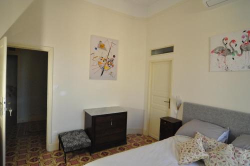 a bedroom with a bed and a dresser in it at Relais des Vignerons, Chambres d'hôtes in Conilhac-Corbières