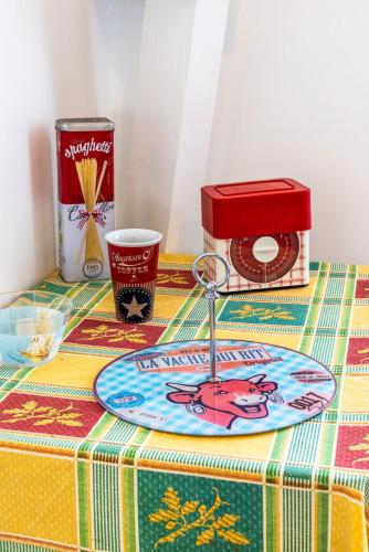 a table with a plate and a red box on it at Beautiful apartment, shops within walking distance, Vannes 5 min in Plescop