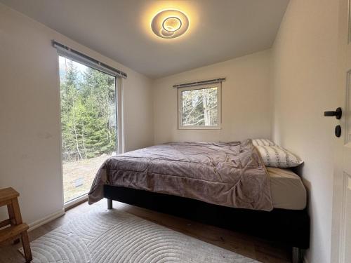a bedroom with a bed and a window at Cozy holiday home near the lake, perfect for the family in Bredared