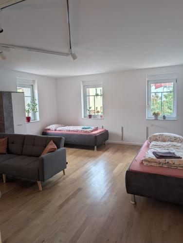 a living room with two beds and a couch at Brick House in Frohburg