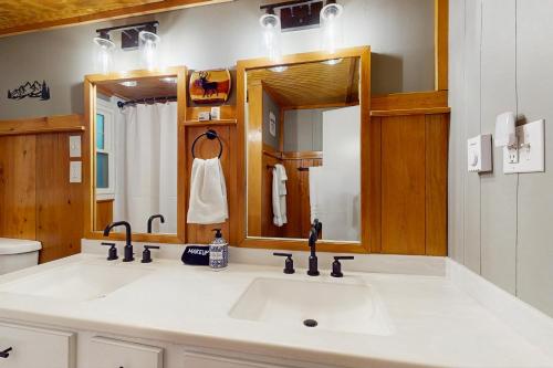 a bathroom with a sink and a mirror at Tree Top Cabin in Beech Mountain