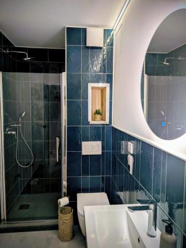 a bathroom with a shower and a toilet and a sink at Brick House in Frohburg