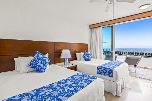 Postel nebo postele na pokoji v ubytování Grand Miramar A601