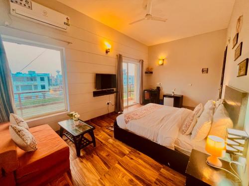 a bedroom with a bed and a large window at Hotel Meena Laxmi Inn 