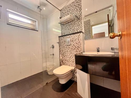 a bathroom with a toilet and a sink at Hotel Meena Laxmi Inn 