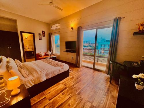 a hotel room with a bed and a large window at Hotel Meena Laxmi Inn 