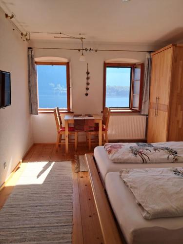 a room with two beds and a table and chairs at Haus Franziska in Hallstatt