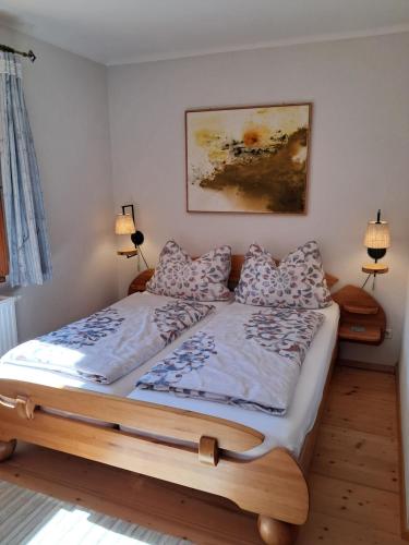 a bedroom with a wooden bed with two pillows at Haus Franziska in Hallstatt