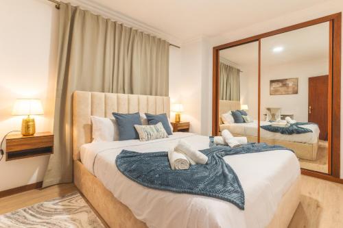 a bedroom with two beds and a large mirror at Stero House by Atlantic Holiday in Caniçal