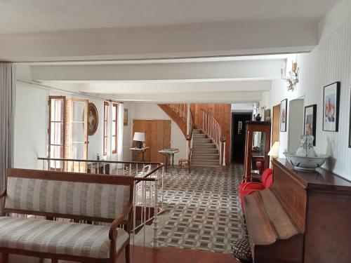 a living room with a couch and a staircase at Le Mas Palegry Chambres d'hôtes Perpignan in Perpignan