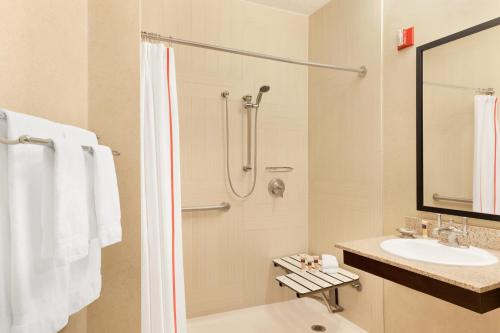 a bathroom with a shower and a sink at Hotel Lincoln in Chicago