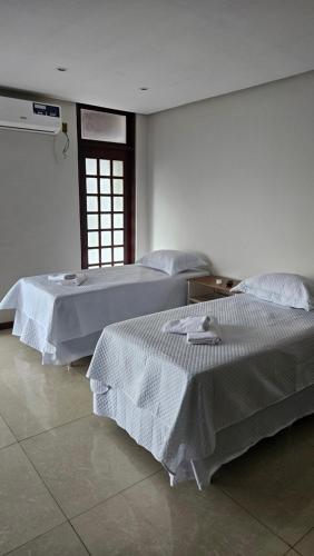 Ein Bett oder Betten in einem Zimmer der Unterkunft Mendes Residence