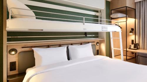 a bedroom with a bed and a bunk bed at Campanile Paris Ouest - Nanterre - La Défense in Nanterre