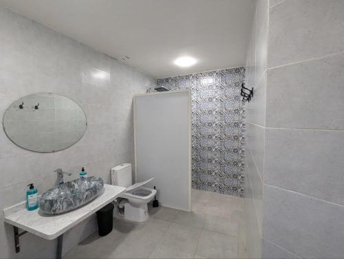 a bathroom with a toilet and a sink and a shower at Dar BERNANI in Rabat