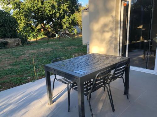 a black table and chairs sitting on a porch at Maison d'hôtes à Saix in Saix
