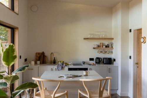 a kitchen with a table and chairs in a room at The Lodge Burniston in Scarborough