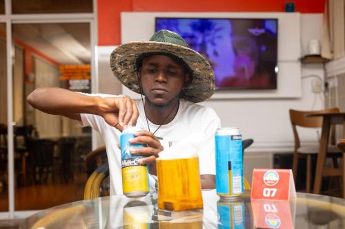 a man wearing a hat sitting at a table at Hotel Windsor-Mombasa in Mombasa