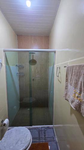 a shower with a glass door in a bathroom at Loft Hipolito in Belém