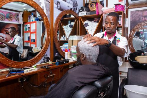 a man getting his hair cut in a barber shop at Hotel Windsor-Mombasa in Mombasa