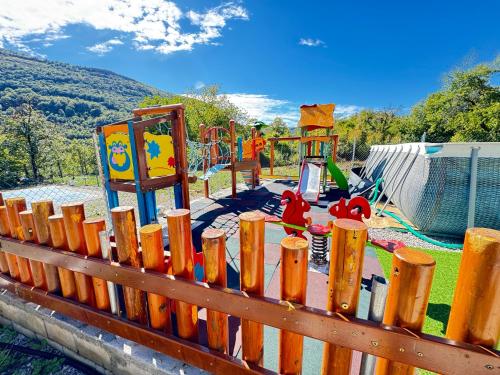 a playground with a wooden fence and a play area at Lipite Guest House in Yantra