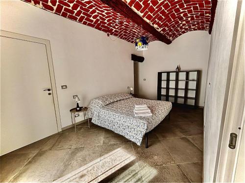 a bedroom with a bed and a red brick ceiling at Poseidone in Trofarello