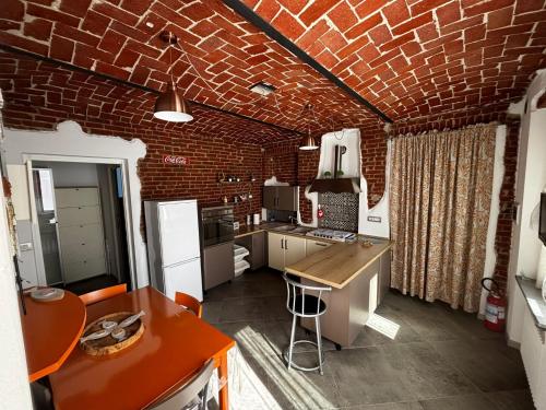 a kitchen with a brick wall and a counter top at Poseidone in Trofarello
