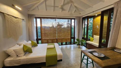 a bedroom with a bed and a large window at Casa Selvita in Kandy