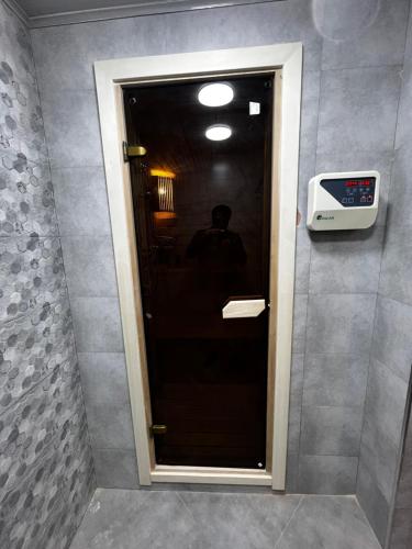 a door to a bathroom with a television on the wall at Luxury Villa in Ismayilli in İsmayıllı