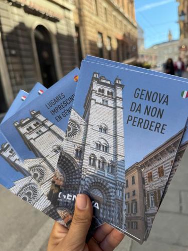 a person holding up a picture of a building at Casa Mia Sea&Center in Bogliasco