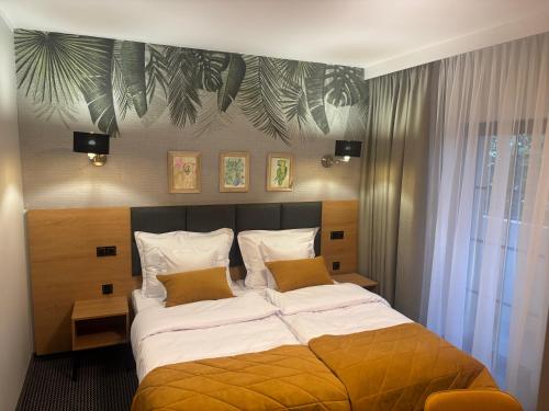 a bedroom with a large bed in a room at Villa Parkova Strzelin in Strzelin