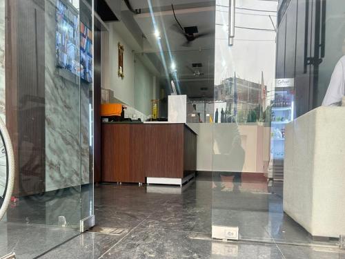 a lobby with a counter in a building at Akshay premium suites1 BHK Serviced Apartments Near Artemis Hospital Sector 52 in Gurgaon