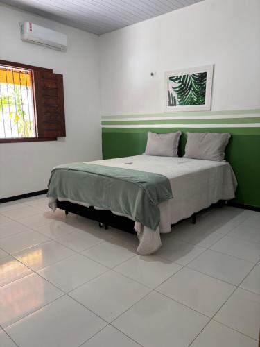 a bedroom with a large bed in a room with a window at Casa Viturino in Tailandia