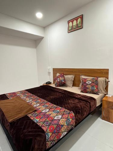 a bedroom with a large bed with at Hotel Bhakti Pride Panchvati Nashik in Nashik