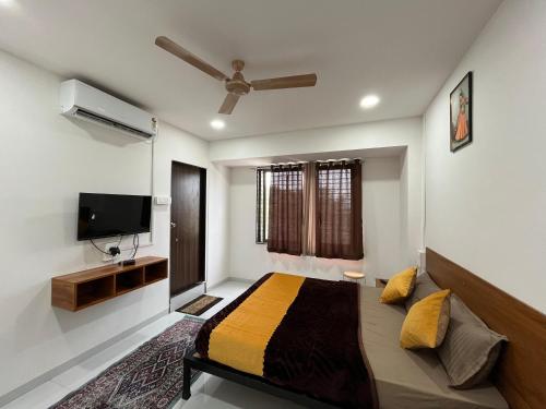 a bedroom with a bed and a flat screen tv at Hotel Bhakti Pride Panchvati Nashik in Nashik