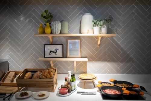 a table with a buffet of food on it at voco Bilbao - City by IHG in Bilbao