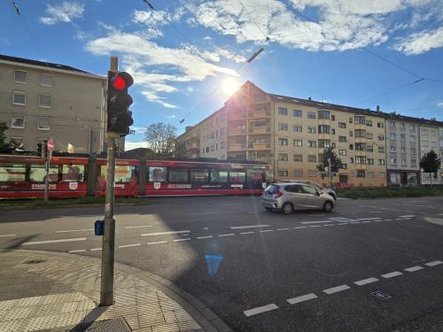a traffic light and a car on a city street at Top-Floor Hideaway for Two in Karlsruhe-Mühlburg - APOLONIAliving - Apt3 in Karlsruhe