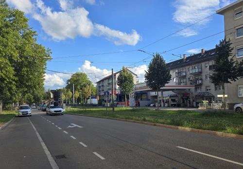 a street with cars driving down the street at Top-Floor Hideaway for Two in Karlsruhe-Mühlburg - APOLONIAliving - Apt3 in Karlsruhe