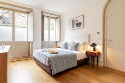 a bedroom with a bed with a tray of fruit on it at Central & Cozy Studio by HostWise in Vila Nova de Gaia